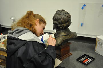 Kathryn working on a copper alloy bust